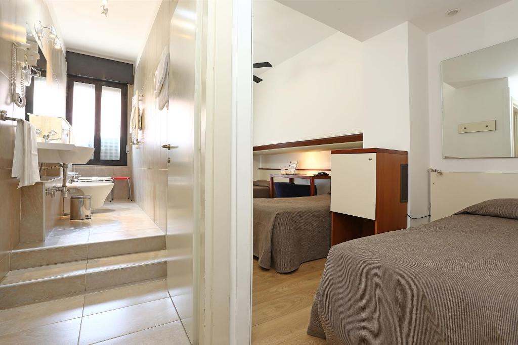 Postel nebo postele na pokoji v ubytování Hotel Corticella