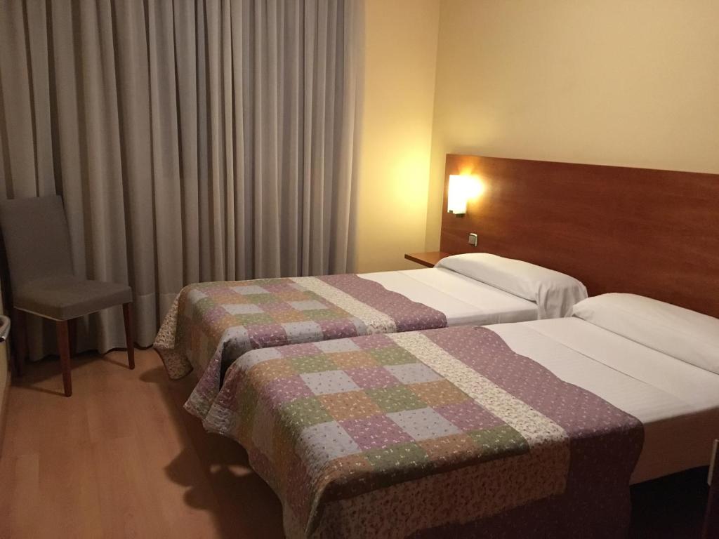 Postel nebo postele na pokoji v ubytování Hotel Torre Monreal
