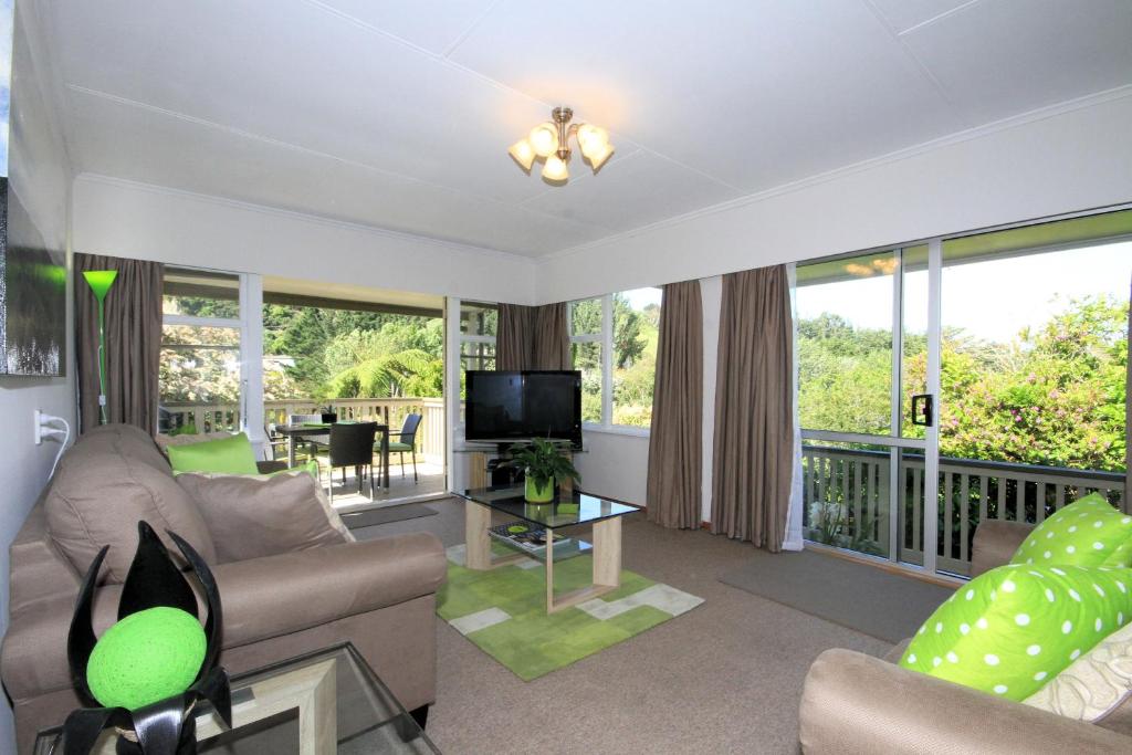 sala de estar con sofá y TV en Durie Vale Retreat, en Whanganui