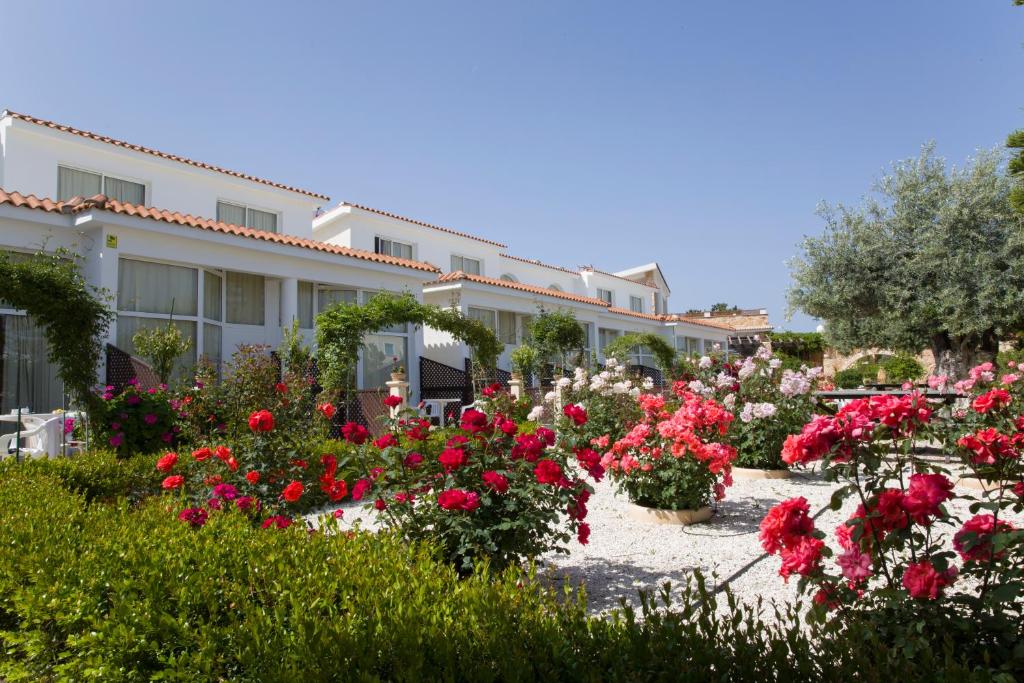 a garden of flowers in front of a building at Eliofos Elegant Maisonettes in Polis Chrysochous