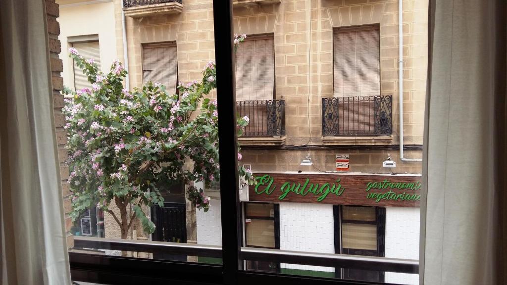 a window view of a building with a sign on it at Poeta Campos Vasallo 19 in Alicante