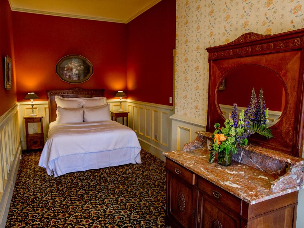 a hotel room with a bed and a mirror at The Inn at 2nd & C in Eureka