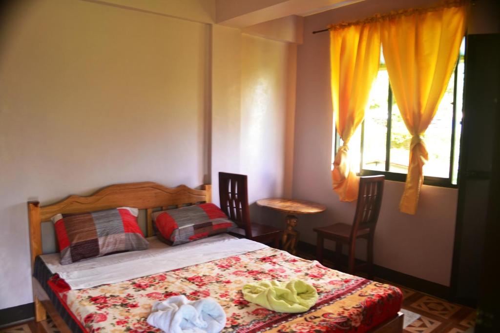 Postel nebo postele na pokoji v ubytování Banaue Greenfields Inn