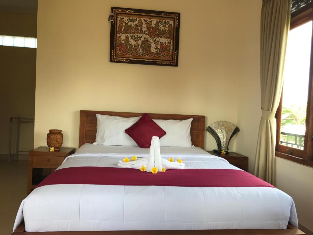 Łóżko lub łóżka w pokoju w obiekcie Taman Ayu Ubud