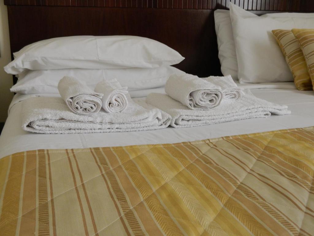 Postel nebo postele na pokoji v ubytování Hotel Le Palme