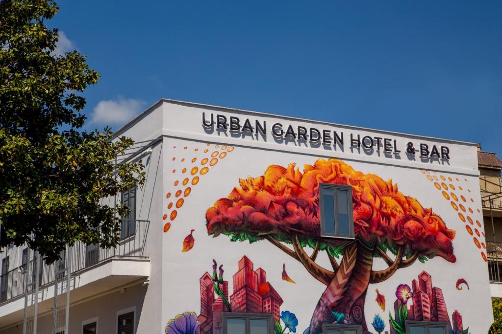 un edificio con un árbol pintado a un lado. en Urban Garden Hotel en Roma