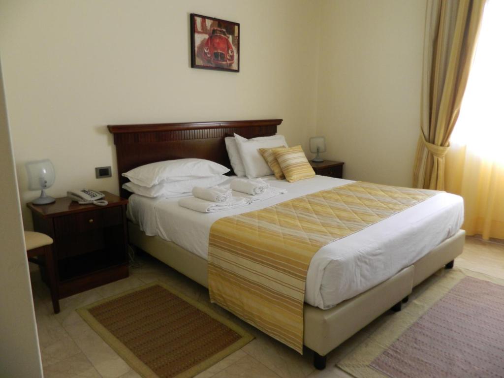 Postel nebo postele na pokoji v ubytování Hotel Le Palme