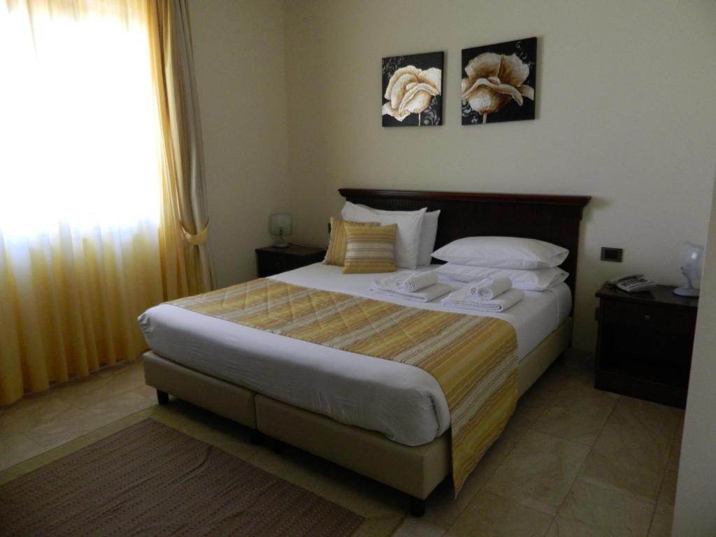 Postel nebo postele na pokoji v ubytování Hotel Le Palme