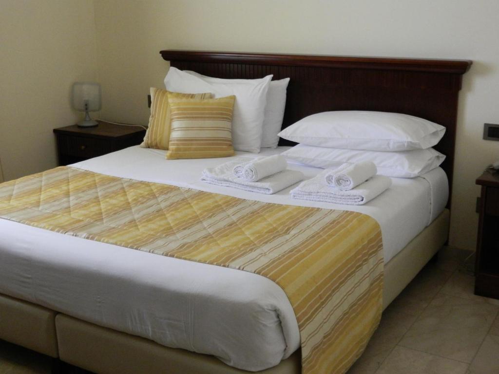 Postel nebo postele na pokoji v ubytování Hotel Le Palme