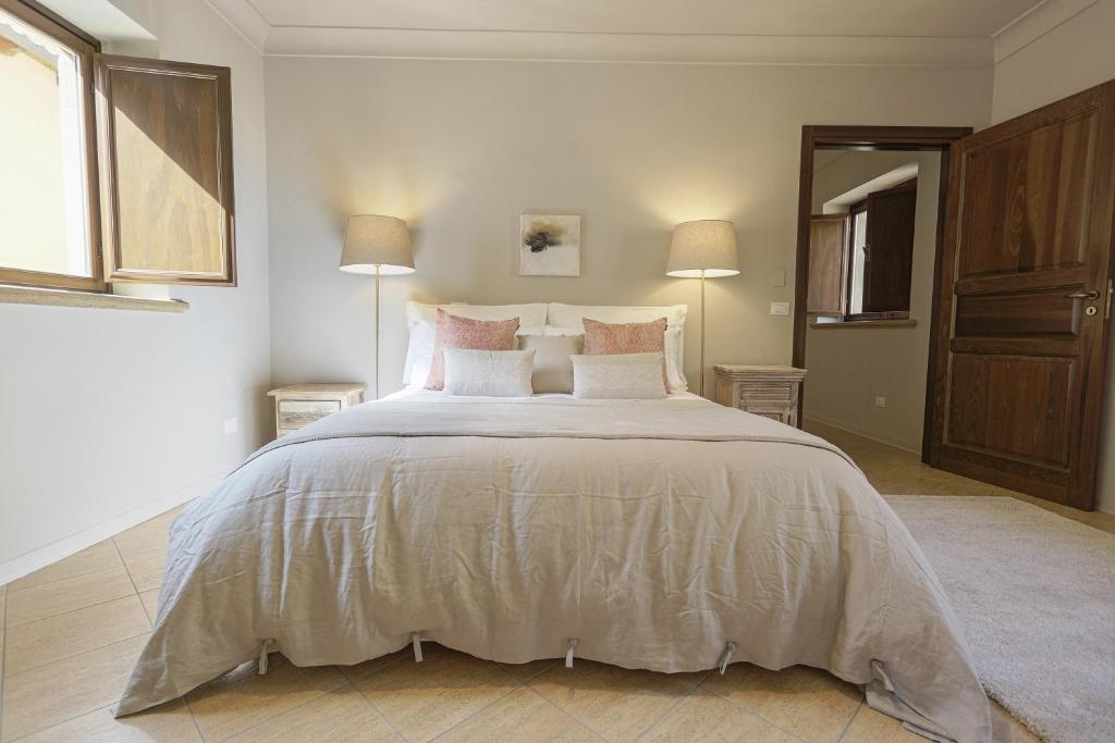 a large bedroom with a large bed with pillows at B&B Palazzo Bibirria in Agrigento
