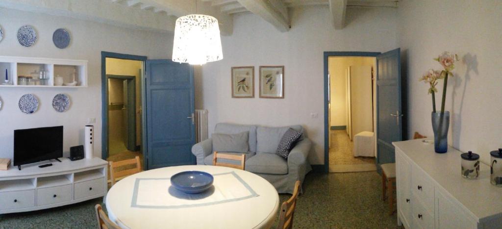 een woonkamer met een tafel en een bank bij Abitare il Borgo Piazza del Popolo in Castagneto Carducci