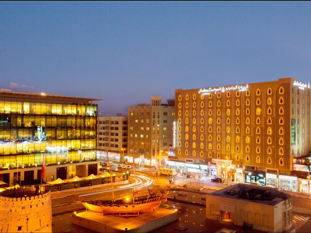 a view of a city at night with buildings at Arabian Courtyard Hotel & Spa in Dubai