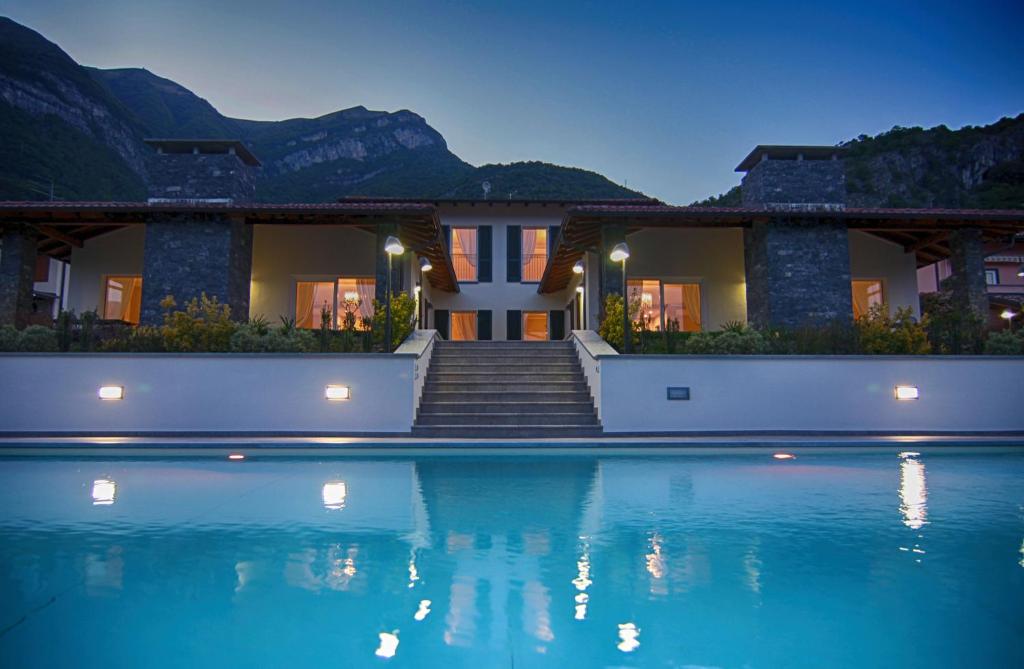 a house with a swimming pool at night at Ville Mirage in Tremezzo