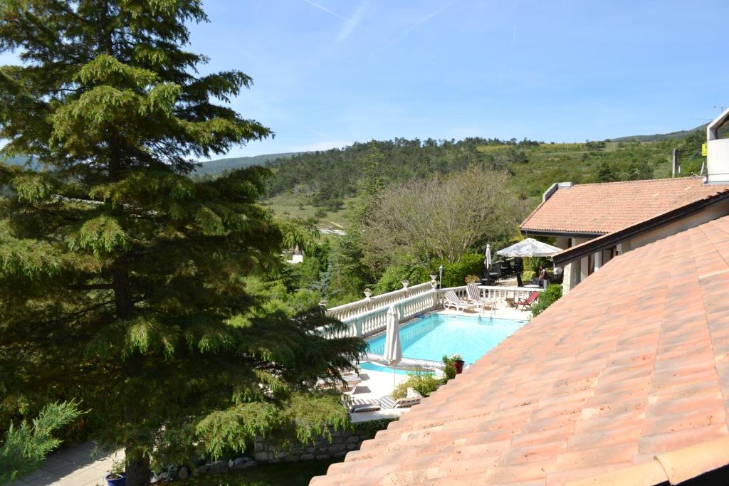a view of a swimming pool from a house at Logis Hôtel Le Vieil Amandier in Trigance