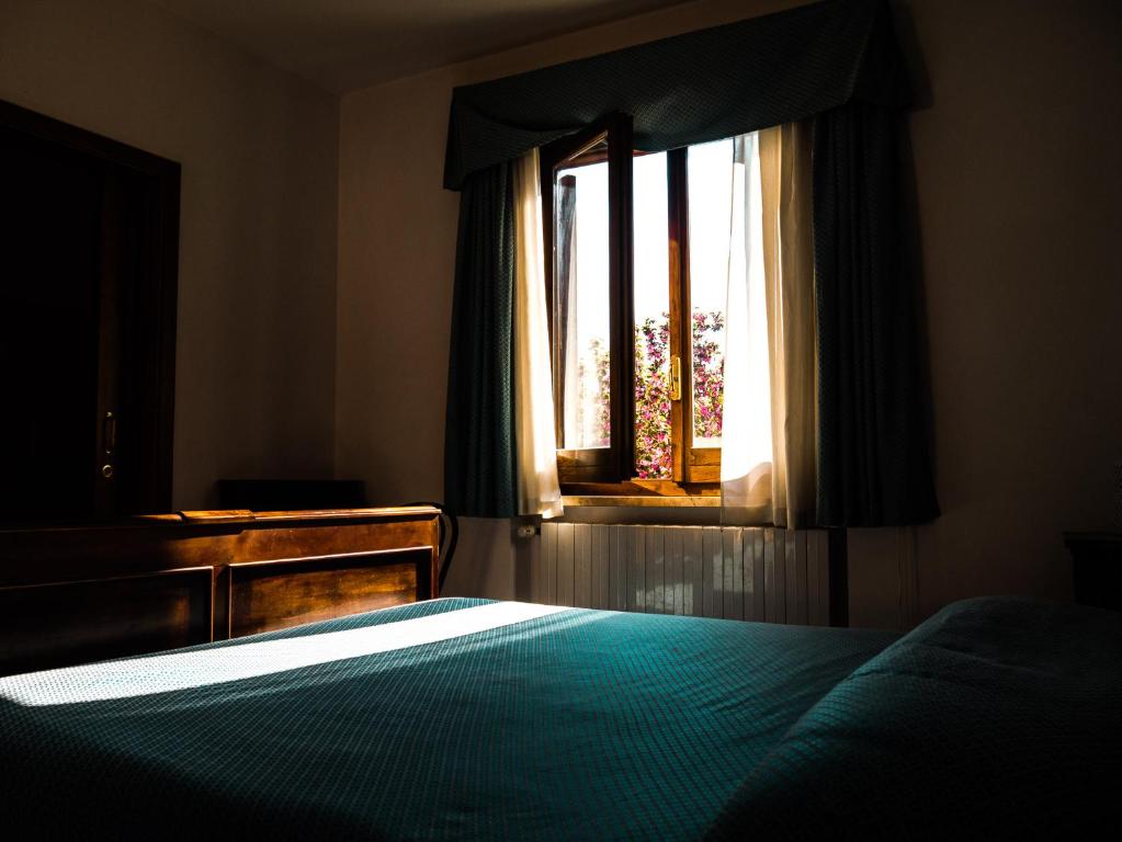 Postel nebo postele na pokoji v ubytování Hotel Albergo Ristorante Il Ciclope