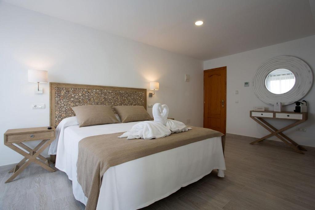a bedroom with a bed with a white towel on it at Hotel Rosamar - Emar Hotels in Es Pujols