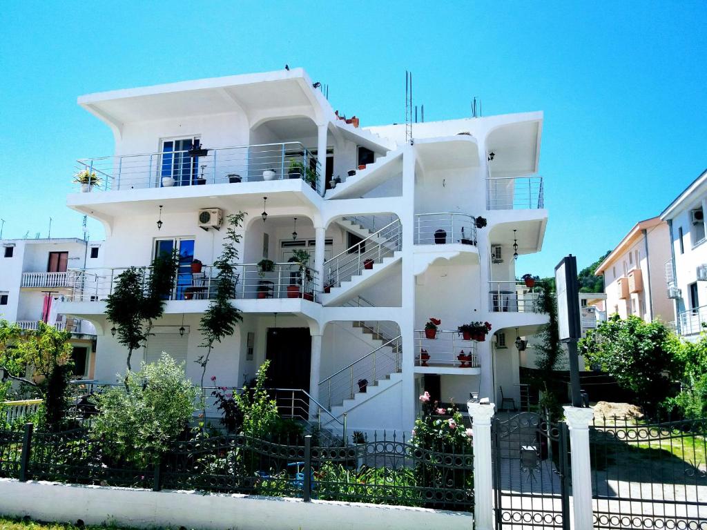 a white building with balconies on the side of it at Apartments Armini in Ulcinj