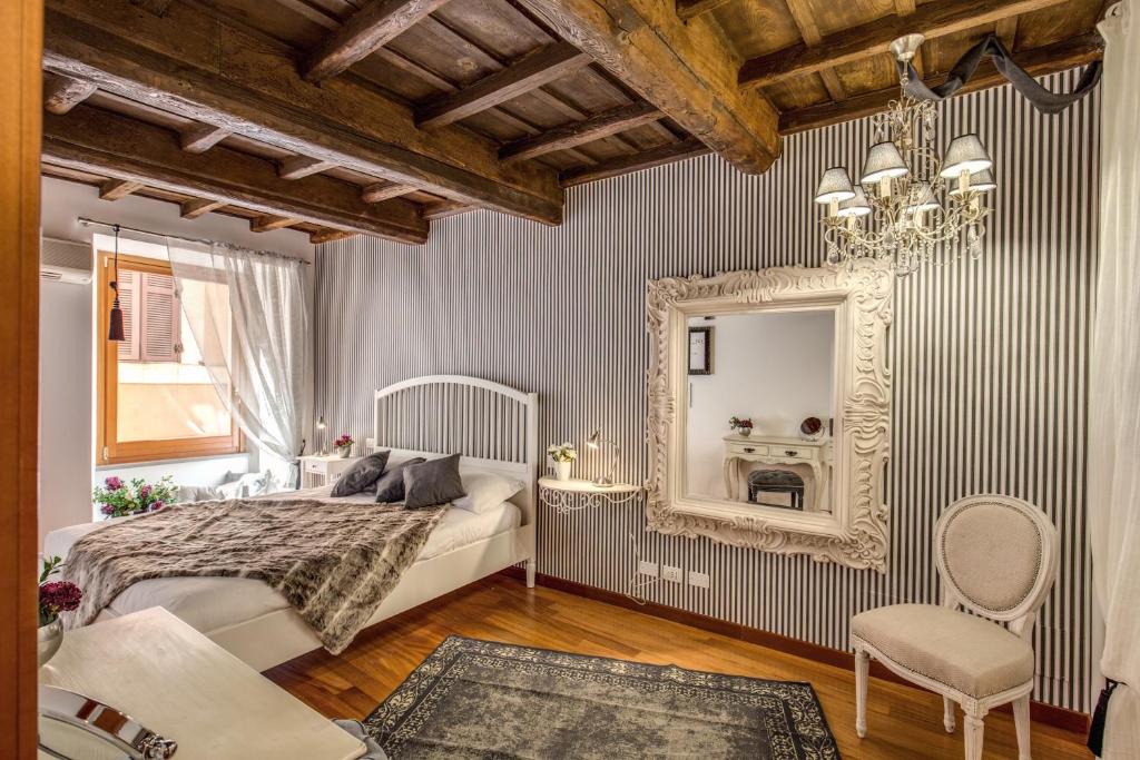 a bedroom with a bed and a mirror and a chair at Pantheon Miracle Suite in Rome