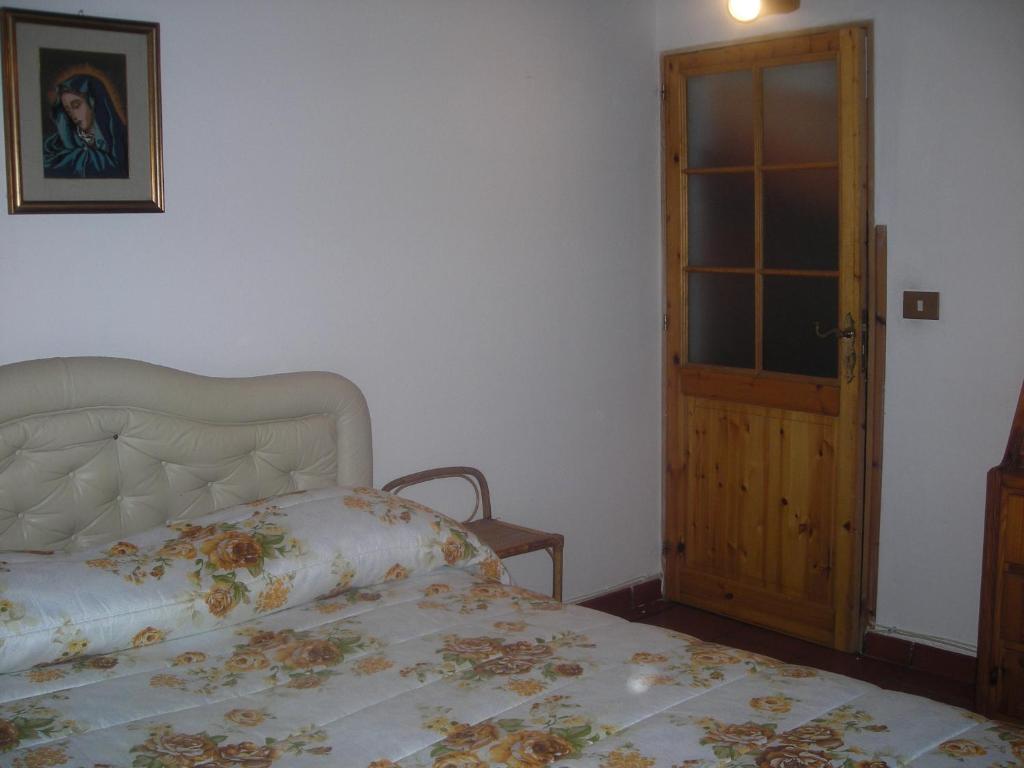 Postel nebo postele na pokoji v ubytování B&B L'Arcobaleno