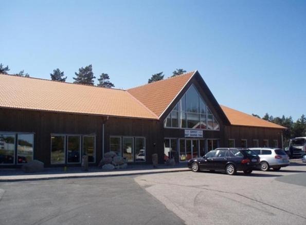 a large building with cars parked in front of it at Vip Mullsjö in Mullsjö