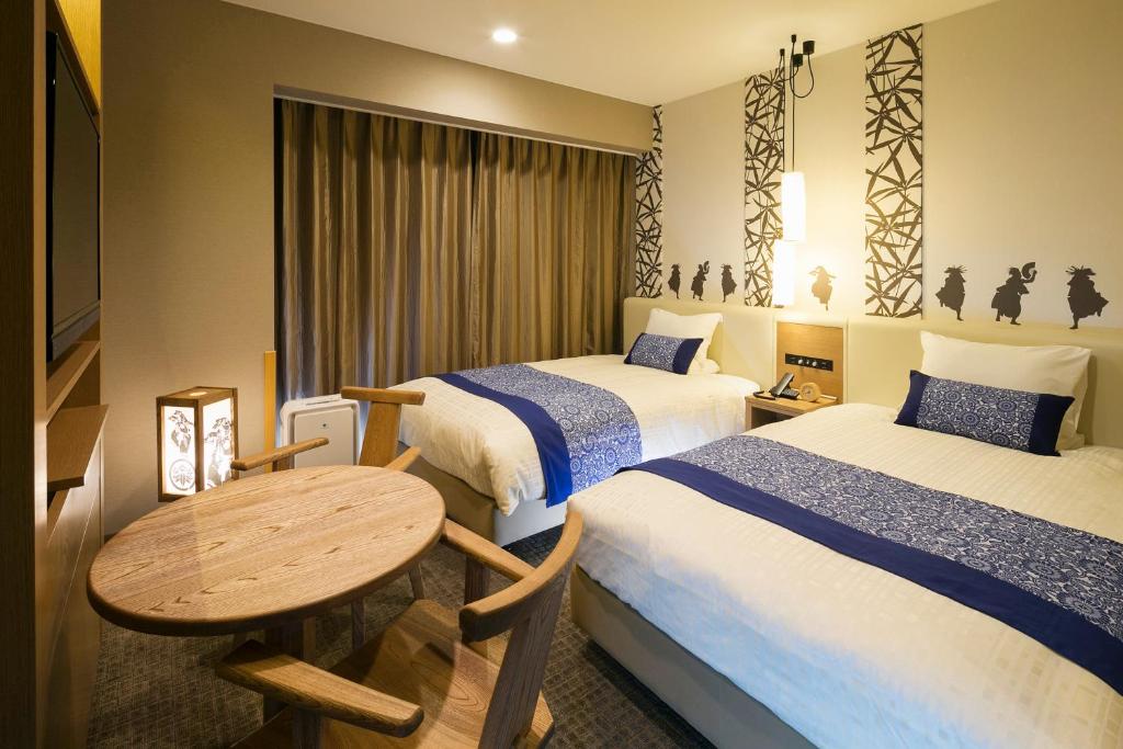 Postel nebo postele na pokoji v ubytování JR-East Hotel Mets Kitakami