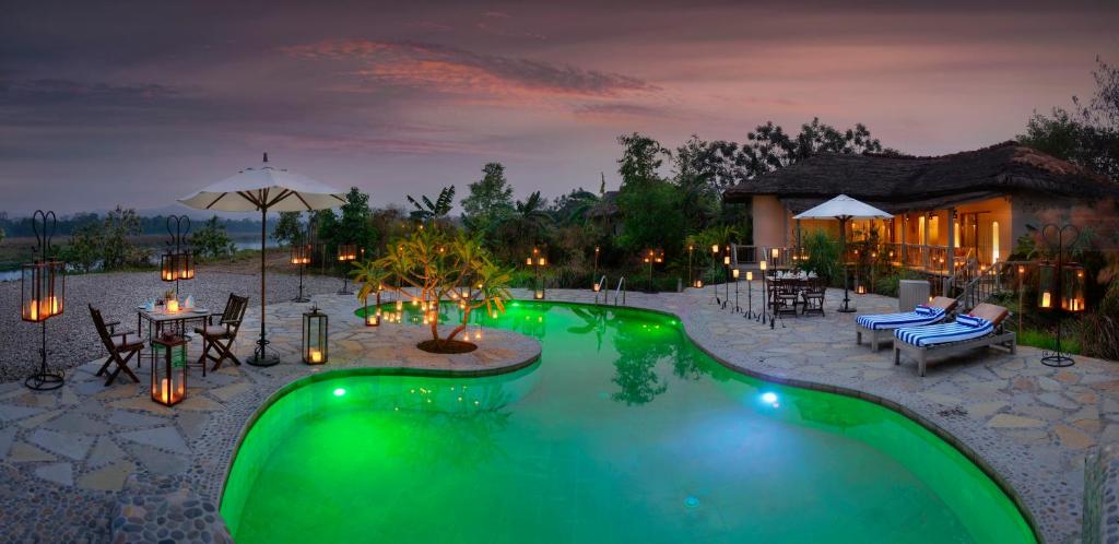 a swimming pool in the middle of a resort at Barahi Jungle Lodge in Meghauli