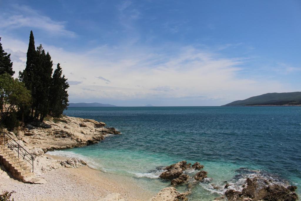 a view of the ocean from a rocky shore at Little Paradise - charming apartment in Labin