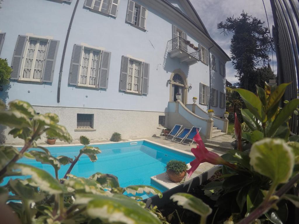 a house with a swimming pool next to a building at Villa Annamaria B&B in Domaso