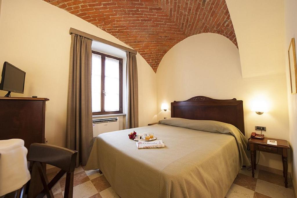 Posteľ alebo postele v izbe v ubytovaní Albergo La Corte Albertina