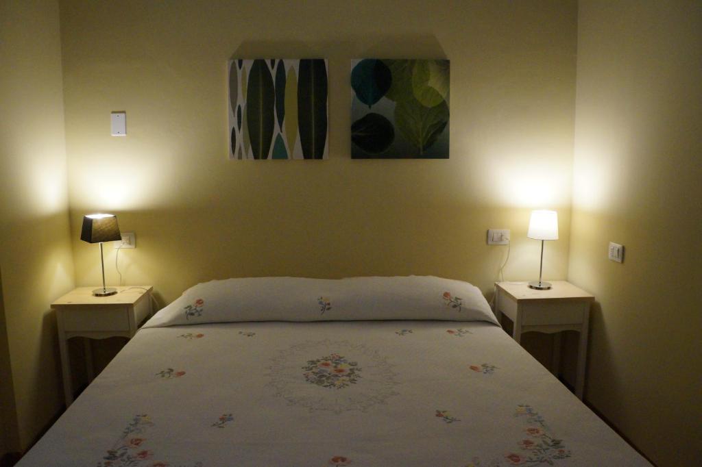 a bedroom with a bed with two lamps on both sides at Il Vicolo 48 in Pesaro
