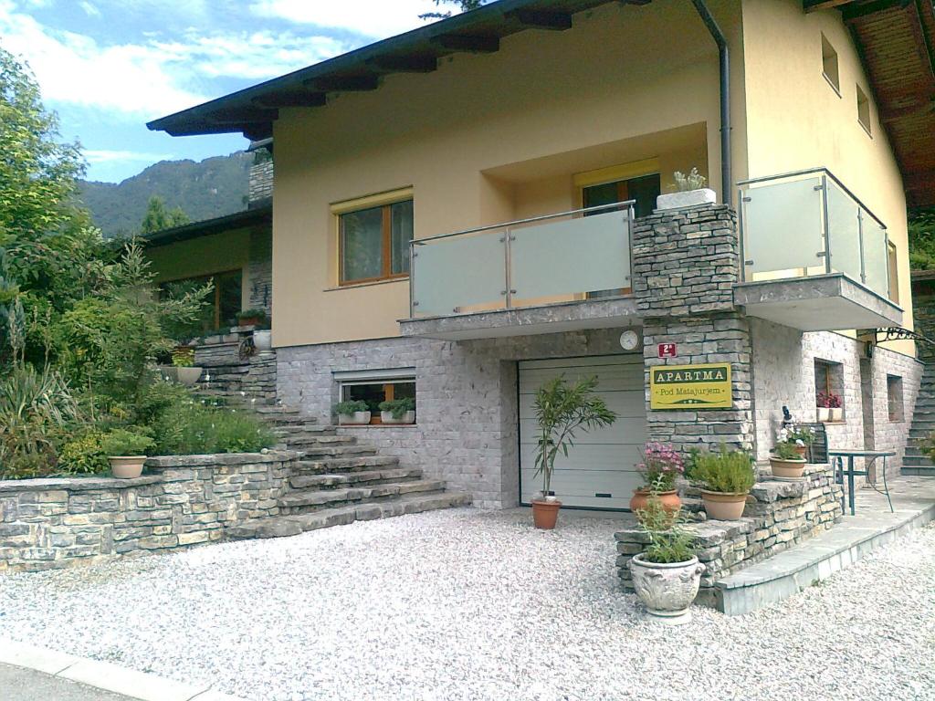 a building with a balcony on the side of it at Apartma "Pod Matajurjem" in Kobarid