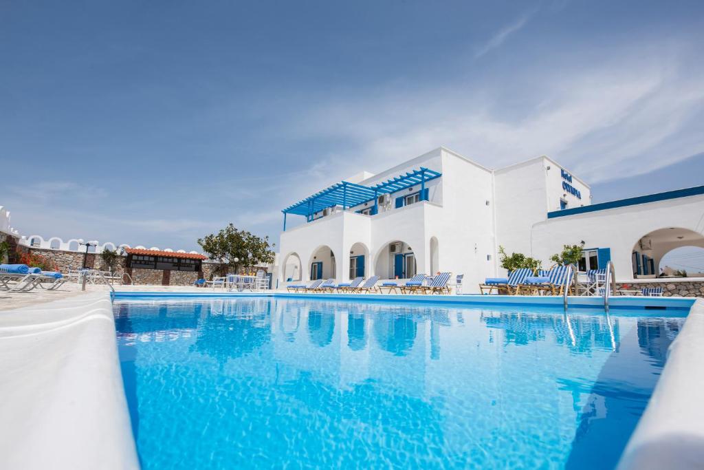 a large swimming pool in front of a building at Hotel Olympia in Karterados