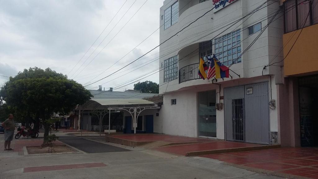 a building with flags on the side of it at Hotel La Vieja Sara in Valledupar