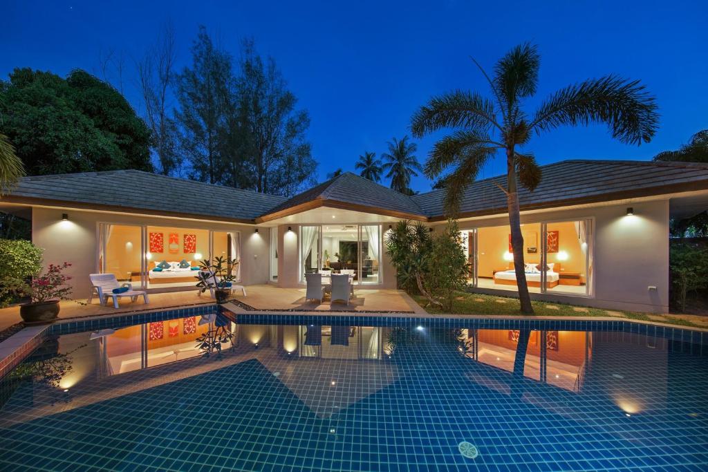 a villa with a swimming pool at night at Lipa Talay Haa - 2 Bed Pool Villa - 1 Minute Walk To Beach in Lipa Noi