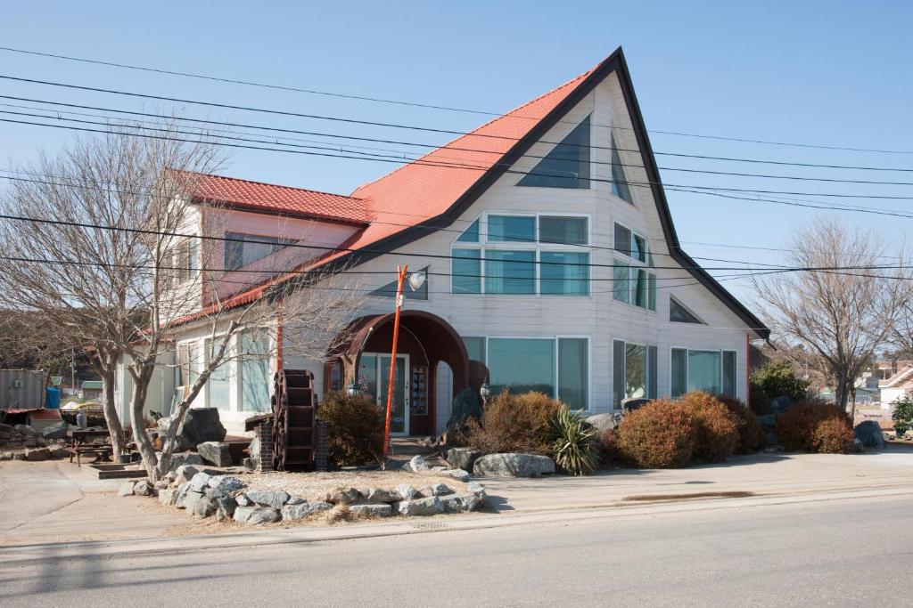 a house with an orange roof on a street at Sunrise Pension in Hwaseong