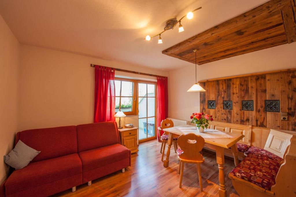 a living room with a couch and a table at Zugspitzhotel Diana Thörle in Ehrwald