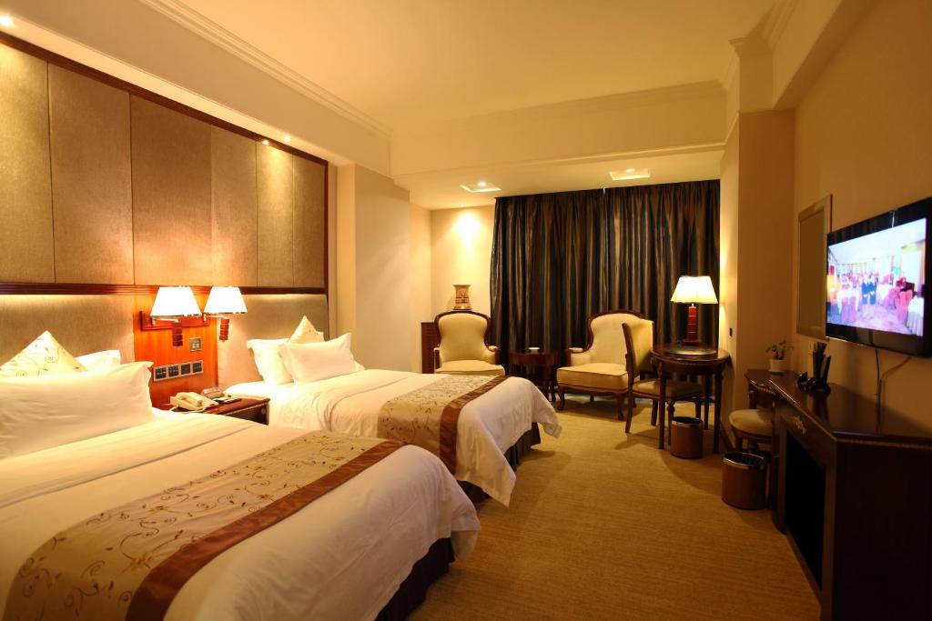 Postel nebo postele na pokoji v ubytování Rongjiang Hotel