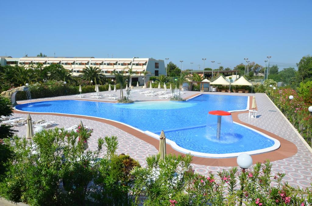 a large swimming pool in the middle of a resort at Alessidamo Club Metaponto in Metaponto