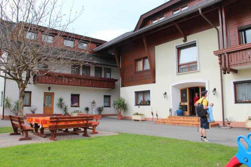 a man standing in front of a building at Pension Duregger in Faak am See