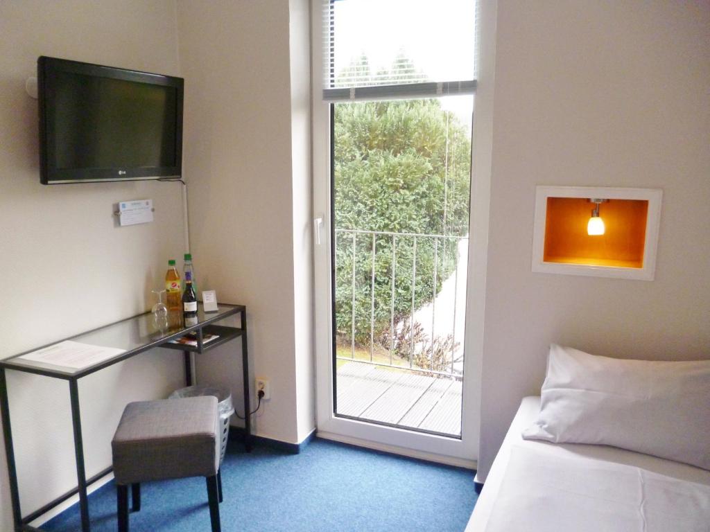 Postel nebo postele na pokoji v ubytování Hotel Am Mühlenteich