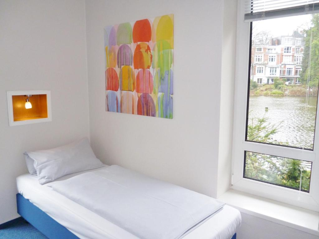 Postel nebo postele na pokoji v ubytování Hotel Am Mühlenteich