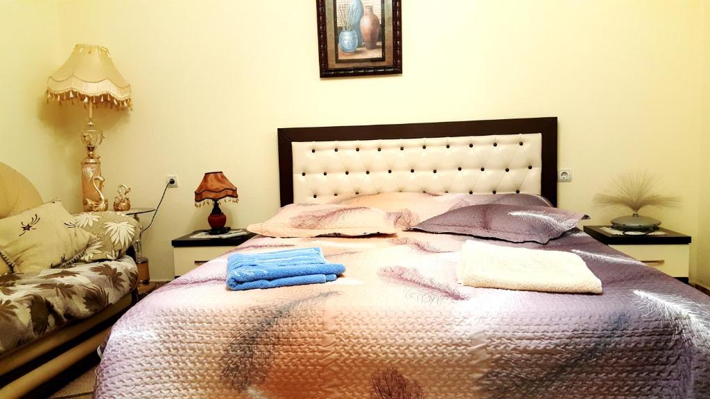 a bedroom with a bed with two towels on it at Berberi Guest House in Pogradec