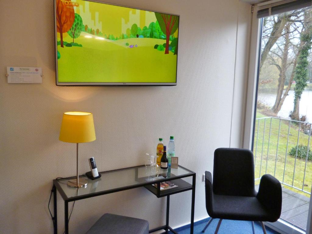 TV a/nebo společenská místnost v ubytování Hotel Am Mühlenteich