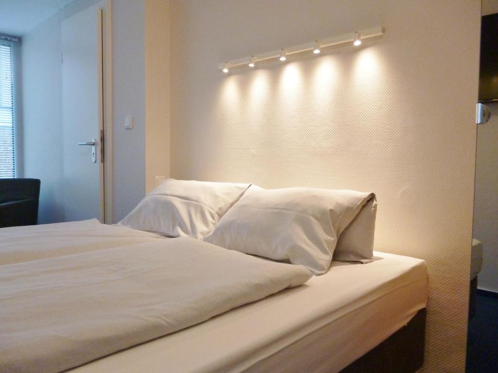 Postel nebo postele na pokoji v ubytování Hotel Am Mühlenteich