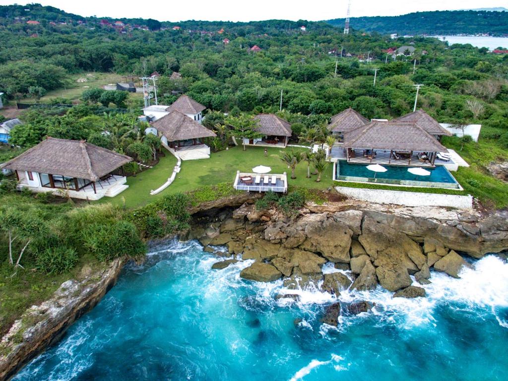 an aerial view of a house on a cliff next to the water at Villa Bahagia in Nusa Lembongan