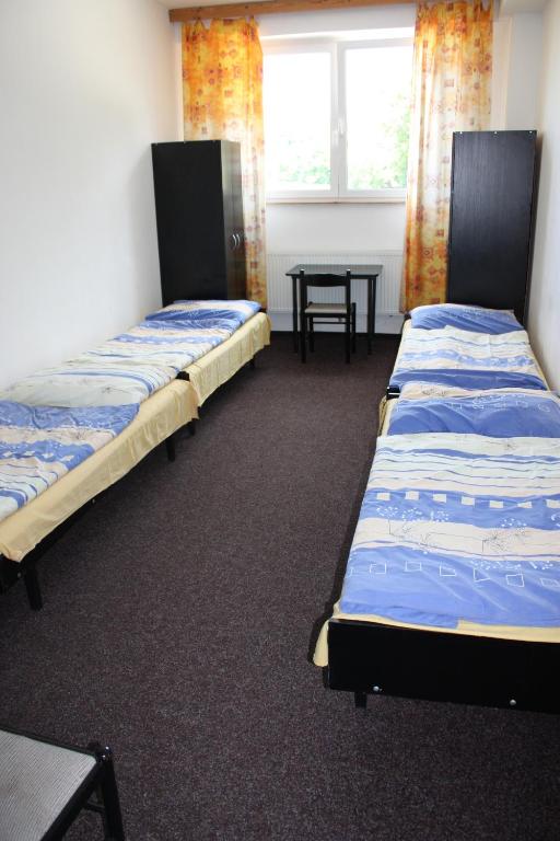 Postel nebo postele na pokoji v ubytování Sporthotel BK Pod Lipou