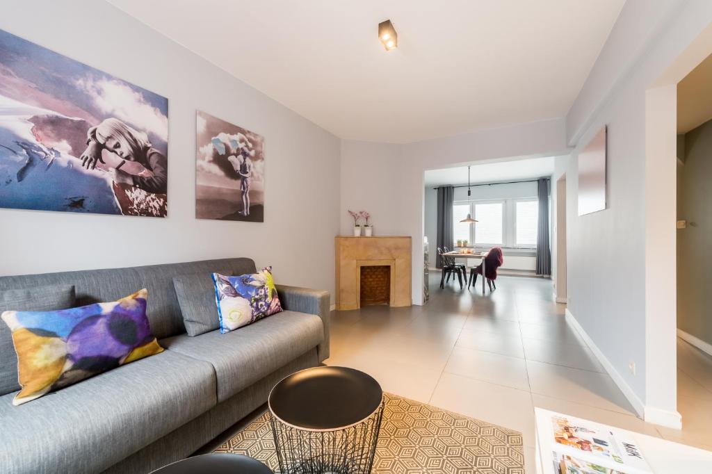 a living room with a couch and a table at Saint-Gangulphe in Liège