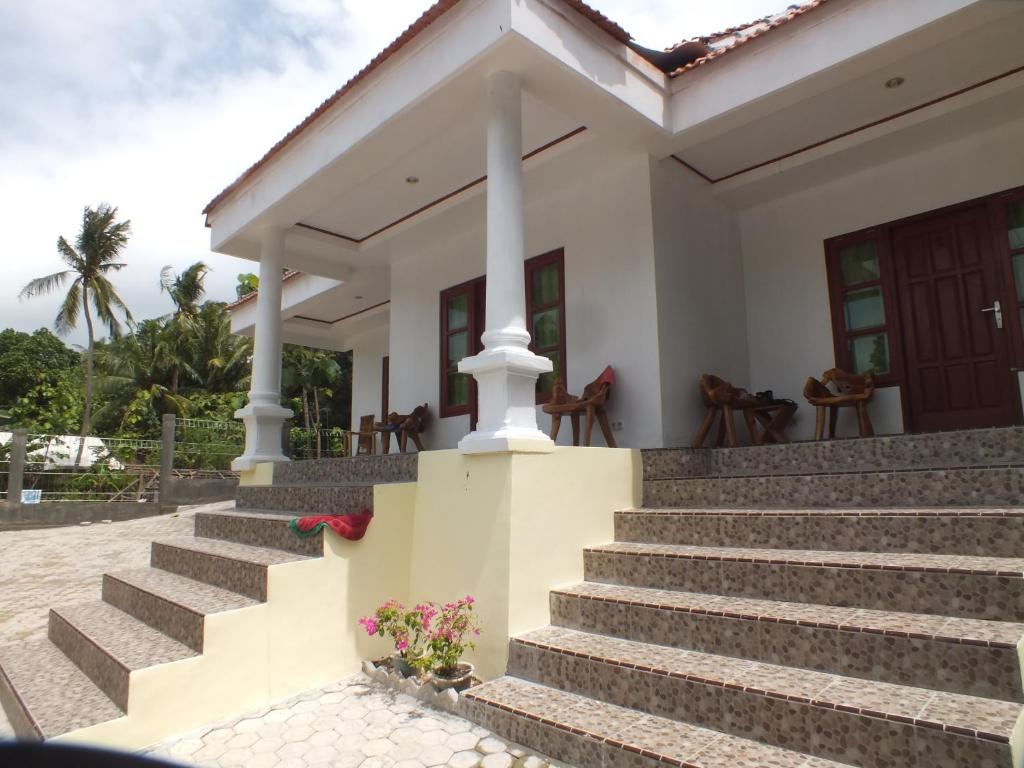 a house with stairs in front of it at Karimunjannah House in Karimunjawa