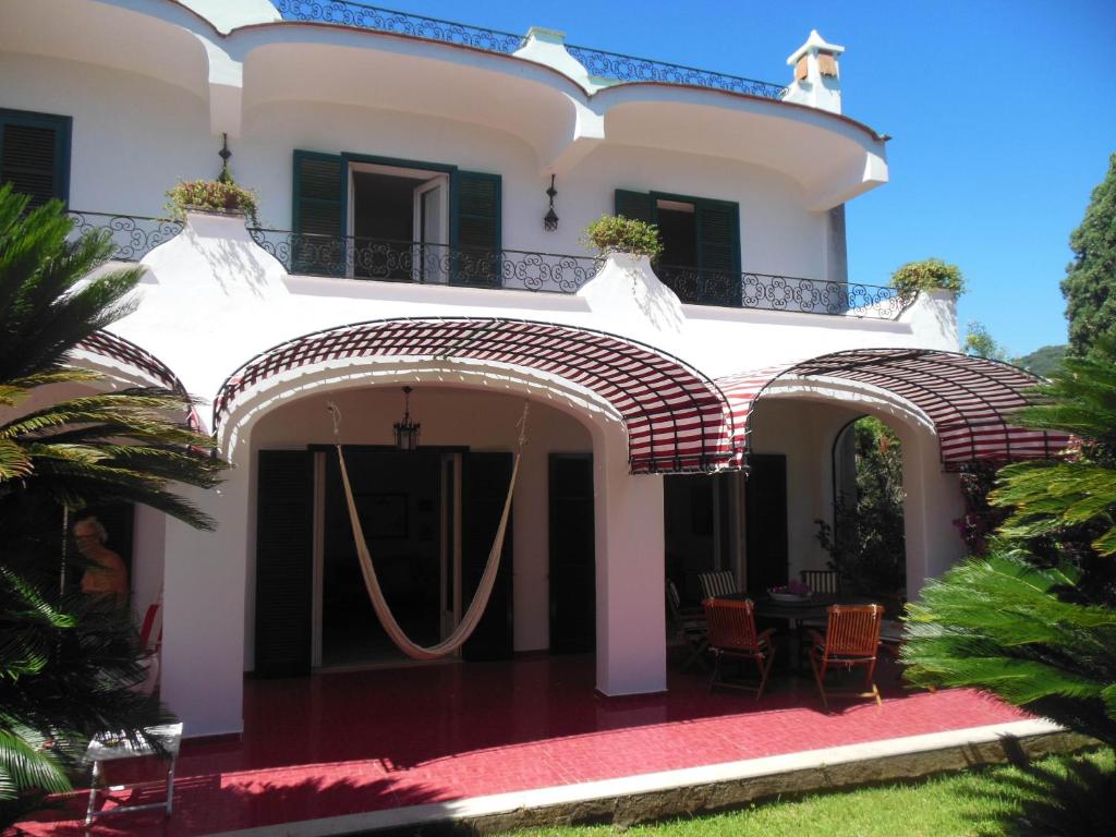 a large white house with a red carpet at Villa Vittoria in Ischia