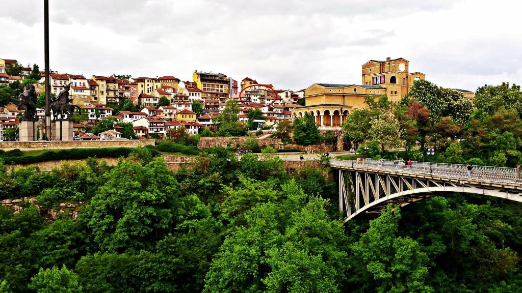 a bridge over a river in a city with buildings at Trendy Inn in Veliko Tŭrnovo